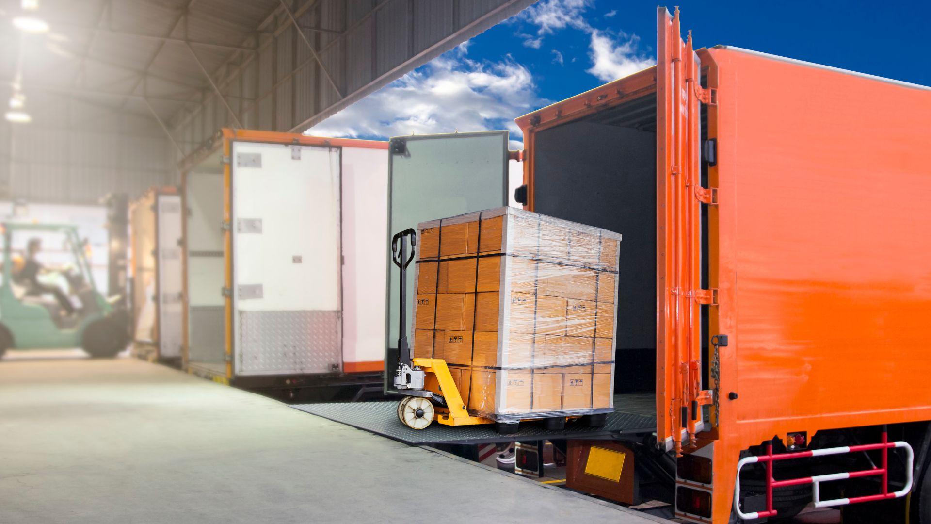 A large orange truck with a bunch of boxes on the back of it