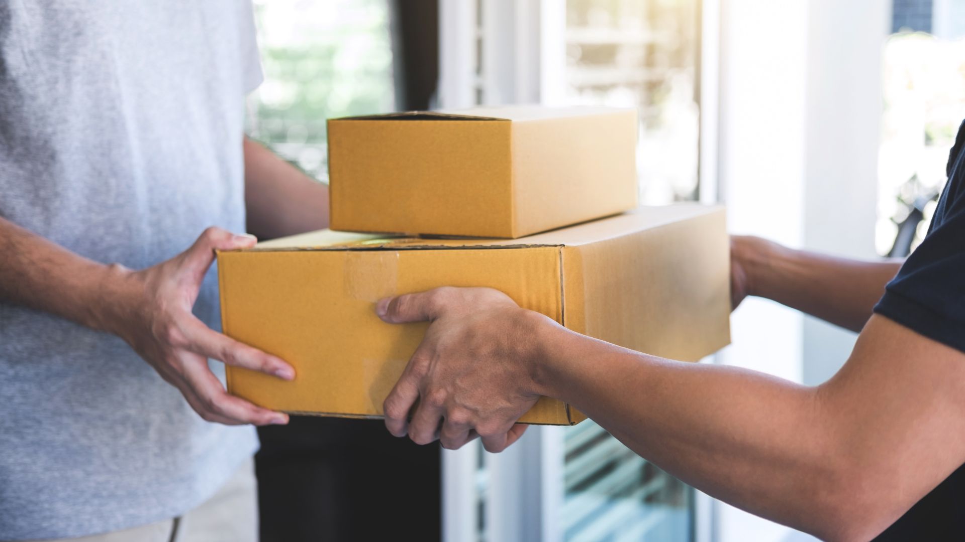 A man is holding a box and another man is holding a box